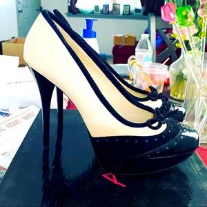 Black and cream wingtip pumps